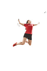 Image showing Young woman playing badminton over white background