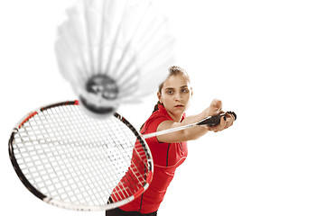 Image showing Young woman playing badminton over white background