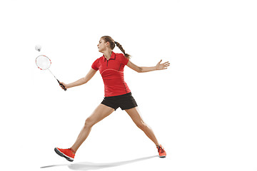 Image showing Young woman playing badminton over white background