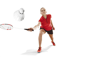 Image showing Young woman playing badminton over white background