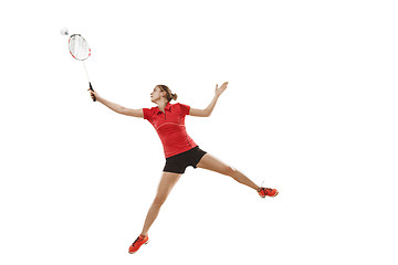 Image showing Young woman playing badminton over white background