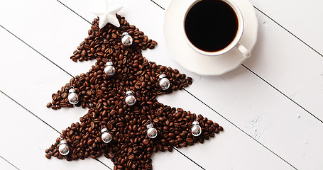 Image showing Beans in shape of fir and cup of coffee