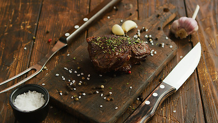 Image showing Cutlery and spices near meat