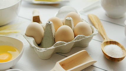 Image showing Cooking ingredients and tools around eggs