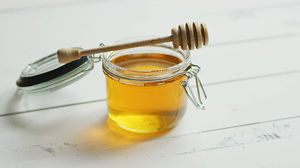 Image showing Jar of honey with spindle