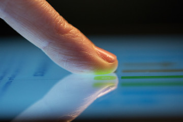 Image showing close up of hand using computer touch screen