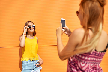 Image showing teenage girl photographing friend by smartphone