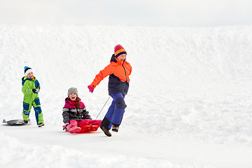 Image showing happy kids with sled having fun outdoors in winter