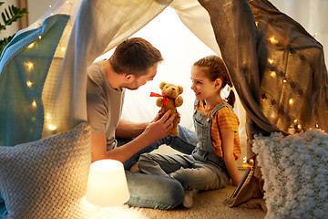 Image showing happy family playing with toy in kids tent at home