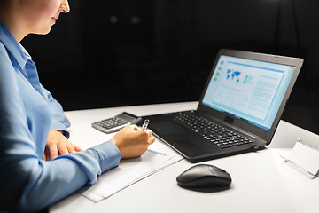 Image showing businesswoman with papers working at night office