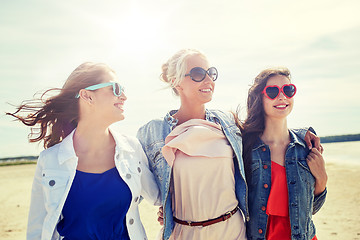 Image showing group of smiling women in sunglasses on beach