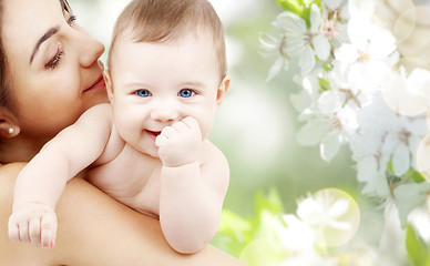 Image showing close up of mother with baby over cherry blossoms