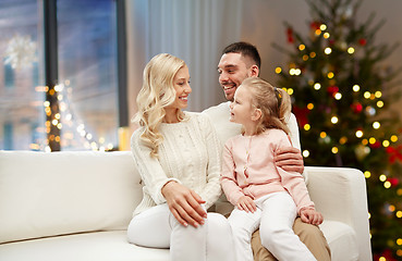 Image showing happy family at home over christmas tree lights