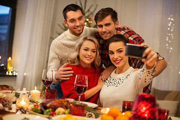 Image showing friends taking selfie at christmas dinner