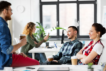 Image showing creative team drinking coffee at office