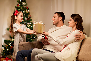 Image showing happy family with christmas present at home