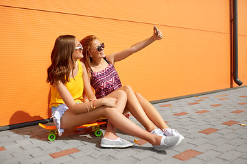 Image showing teenage girls with skateboards taking selfie