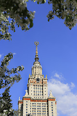 Image showing Moscow State University against sky background with branch of fl