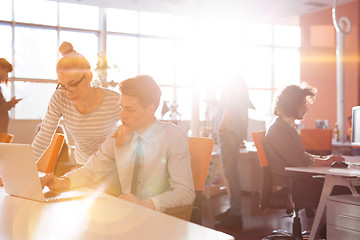 Image showing Young businesswoman helping his colleague at the work