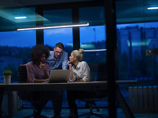 Image showing Multiethnic startup business team in night office