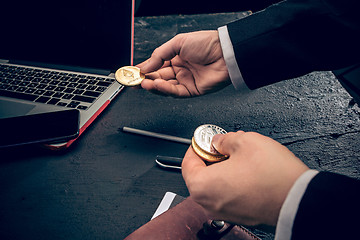 Image showing The golden bitcoin in mail hands