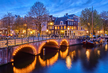 Image showing Amterdam canal, bridge and medieval houses in the evening