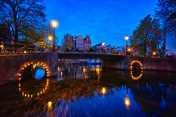 Image showing Amterdam canal, bridge and medieval houses in the evening