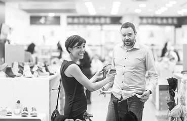 Image showing couple chooses shoes At Shoe Store