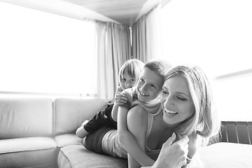 Image showing young mother spending time with kids on the floor