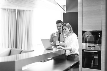 Image showing A young couple is preparing for a job and using a laptop