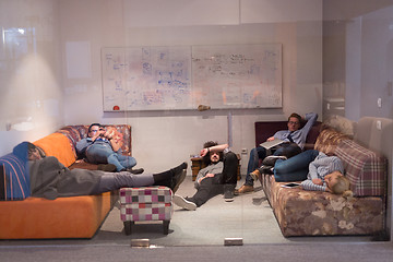 Image showing software developers sleeping on sofa in creative startup office