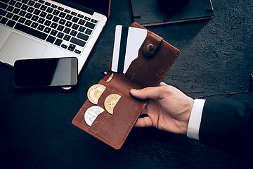 Image showing The golden bitcoin in mail hands