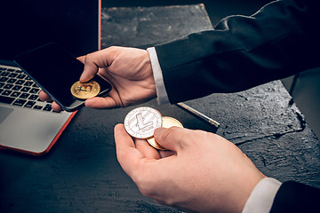 Image showing The golden bitcoin in mail hands