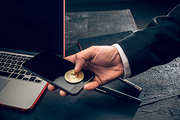 Image showing The golden bitcoin in mail hands