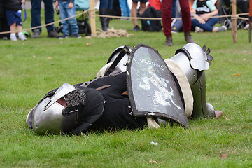 Image showing Medieval warrior in armour lies on the ground in defeat