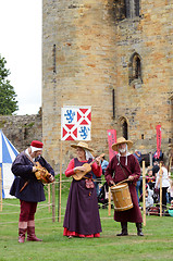 Image showing Three musical minstrels perform on authentic instruments from th