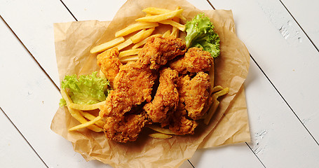 Image showing Lettuce and French fries near chicken wings