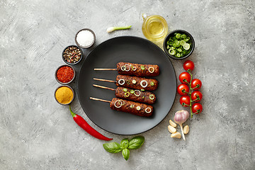 Image showing Barbecued turkey kebab decorated with fresh onion