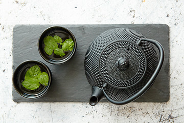 Image showing Traditional eastern metal teapot and iron cups