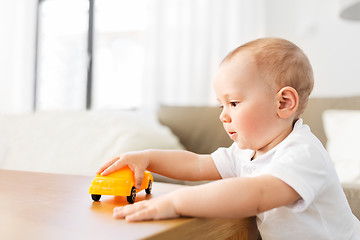 Image showing baby boy playing with toy car at home