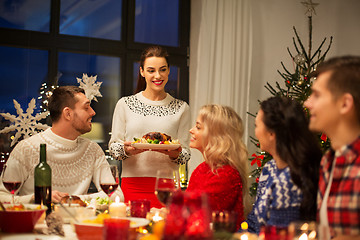 Image showing happy friends having christmas dinner at home