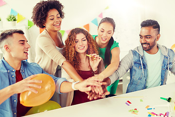 Image showing happy business team at office party holding hands