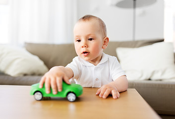 Image showing baby boy playing with toy car at home