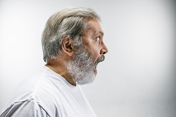 Image showing The senior attractive man looking suprised isolated on white