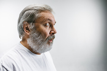 Image showing The senior attractive man looking suprised isolated on white