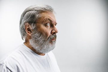 Image showing The senior attractive man looking suprised isolated on white