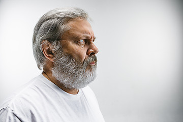 Image showing The profile of serious businessman looking away against white background.