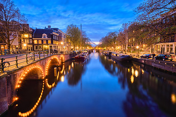 Image showing Amterdam canal, bridge and medieval houses in the evening