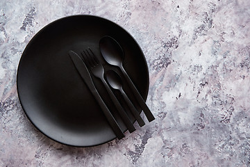 Image showing Top view of black empty plate on marble stone background