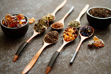 Image showing Spoons with different types of dry tea leaves.